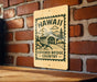 A sign for the Covered Bridge Country, featuring a wooden bridge and the text "HAWAII" and "COVERED BRIDGE COUNTRY" printed on it.