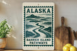 A sign for Barrier Island Pathways in Alaska, featuring a scenic illustration of a winding river surrounded by mountains.