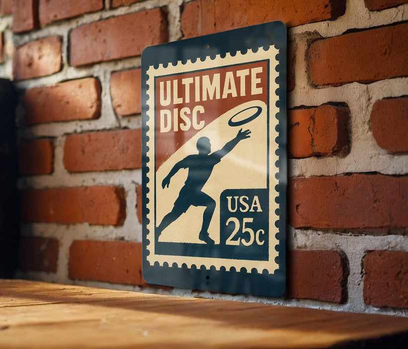 A sign for Ultimate Disc, featuring a silhouette of a person catching a frisbee, mounted on a brick wall.
