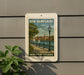 A sign for New Hampshire Harborfront Esplanade is displayed on a wall, featuring a scenic image of a harbor with sailboats and a church steeple.
