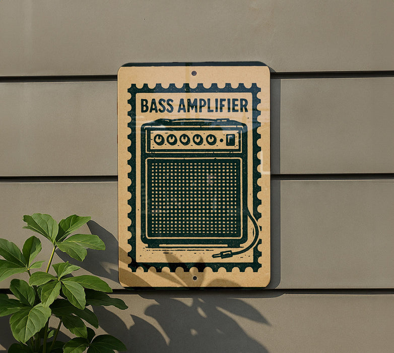 A sign with the text "BASS AMPLIFIER" and an image of a speaker is mounted on a wall next to a plant.