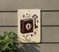 a sign with a key and a book, surrounded by stars and other decorative elements.
