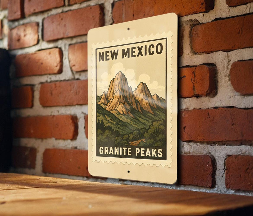 A metal sign with a mountain landscape and the text "NEW MEXICO GRAINITE PEAKS" is displayed on a brick wall.