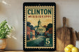 A vintage-style metal sign displaying the text "CLINTON MISSISSIPPI 5 CENTS" is displayed on a shelf, with a potted plant and a wooden cutting board nearby.