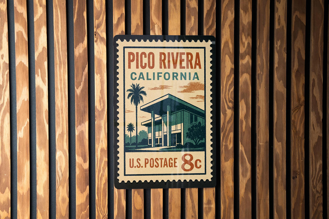 A postage stamp for Pico Rivera, California, with a palm tree and building illustration.