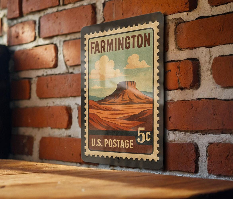 A vintage-style postage stamp from the United States Postal Service, featuring a desert landscape with a mountain in the background.