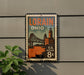 A vintage postage stamp from the United States, featuring an illustration of a bridge and buildings, mounted on a wall.