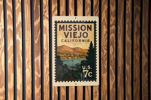 A vintage-style postage stamp from California, featuring a scenic landscape with mountains and a body of water, mounted on a wooden wall.