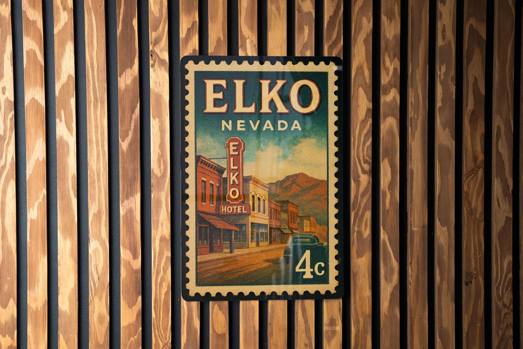 A vintage-style poster of the Elko, Nevada hotel, mounted on a wooden wall.