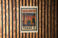 A vintage postage stamp from Harlingen, Texas, featuring a cityscape and a clock tower.