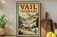 A vintage-style metal sign with a mountain landscape and a cabin, advertising "Vail, Colorado".