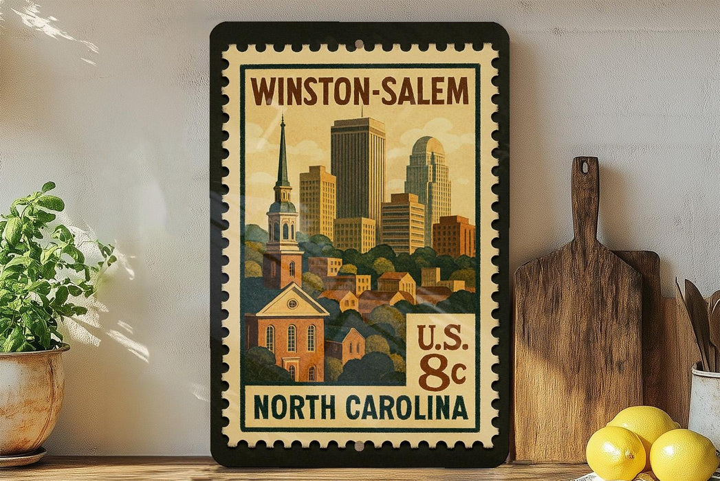A framed vintage postage stamp depicting the Winston-Salem, North Carolina area, with a cityscape and a church.