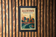 A vintage-style postage stamp from Pennsylvania, featuring an illustration of a cityscape with a bridge and a clock tower.