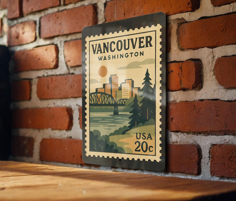 A vintage-style postage stamp from Vancouver, Washington, featuring a cityscape and a bridge, mounted on a brick wall.
