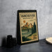 A vintage-style postage stamp from Washington, United States, featuring a cityscape and a bridge, placed on a countertop next to some black camera lenses.