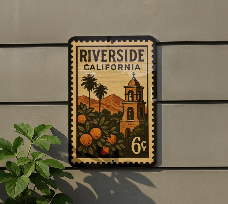 A vintage-style postage stamp from California, featuring a bell tower and palm trees, is displayed on a wall.