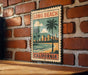 A vintage-style metal sign with a palm tree and beach scene, mounted on a brick wall.