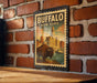 A vintage-style metal sign with the text "BUFFALO NEW YORK" and an illustration of a buffalo in front of a city skyline.