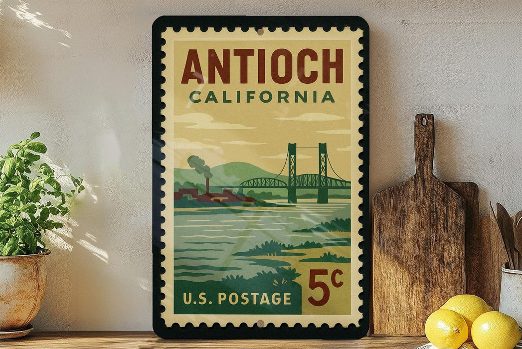 A vintage postage stamp from California, featuring a bridge and a landscape, is displayed on a shelf next to a wooden cutting board and some lemons.