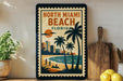 A framed poster of North Miami Beach, Florida, featuring a beach scene with palm trees, a sunset, and a city skyline in the background.