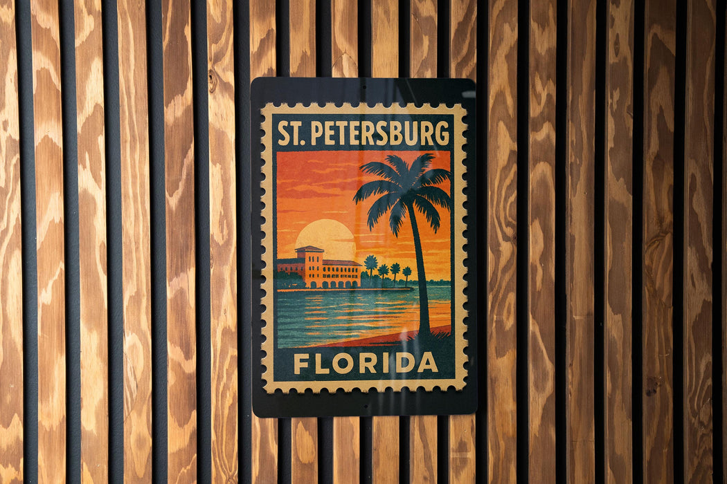 A vintage-style postage stamp depicting St. Petersburg, Florida, with a palm tree and sunset in the background.