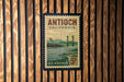 A vintage postage stamp from the United States of America, featuring a scenic illustration of a bridge and water.