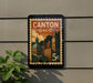 A postage stamp-style sign with the text "CANTON OHIO" and a depiction of a city skyline, mounted on a wall.