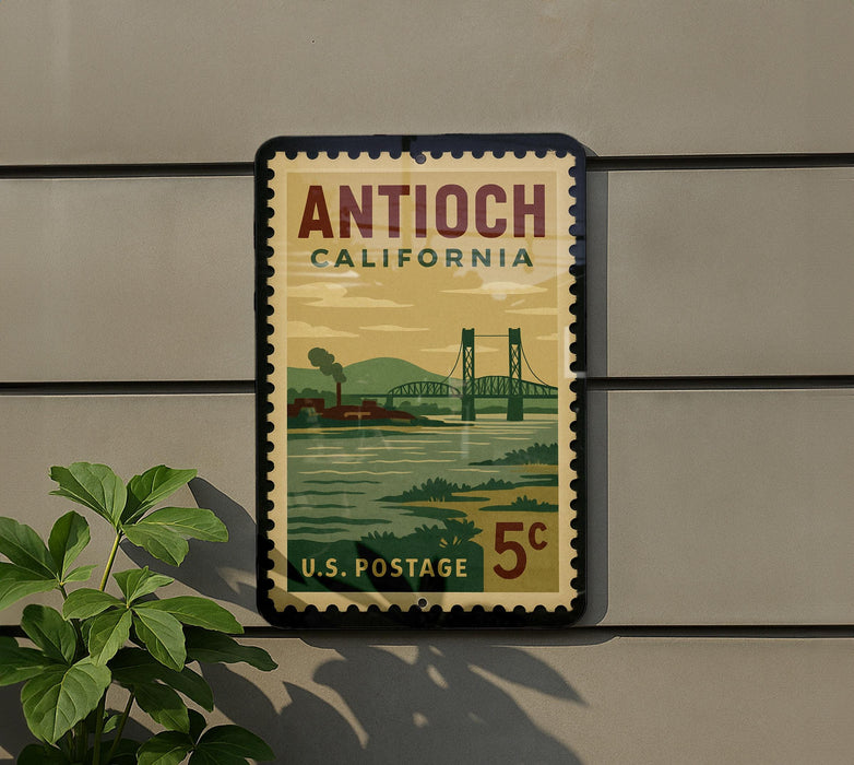 A vintage postage stamp from California, featuring a bridge and a river, mounted on a wall.