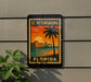 A vintage-style sign for St. Petersburg, Florida, featuring a palm tree and a sunset over a body of water.
