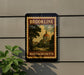 A vintage-style postage stamp from Massachusetts, featuring a building with a dome, is displayed on a wall.