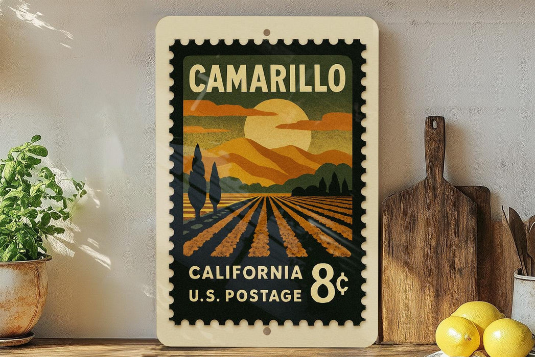 A vintage postage stamp from California, featuring a landscape with a sun and mountains, is displayed on a shelf next to a wooden cutting board and some potted plants.