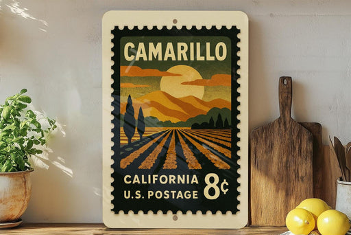 A vintage postage stamp from California, featuring a landscape with a sun and mountains, is displayed on a shelf next to a wooden cutting board and some potted plants.