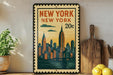 A framed vintage-style stamp depicting the New York City skyline, with the text "NEW YORK NEW YORK 20c" prominently displayed.
