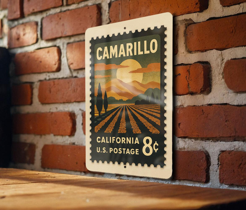 A vintage postage stamp from California, featuring a landscape with a sunset and a field, is displayed on a brick wall.