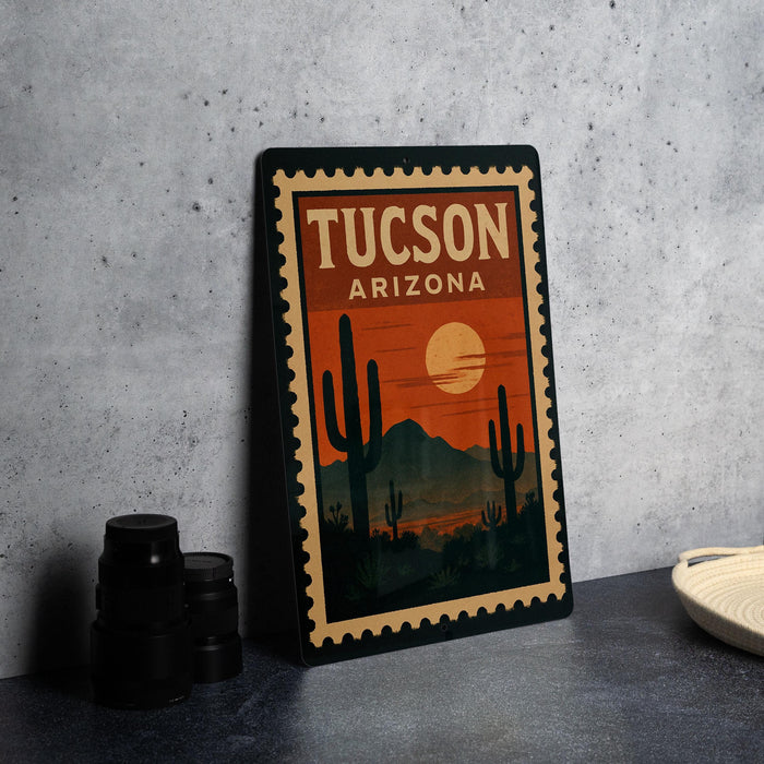 A vintage-style poster of Tucson, Arizona, featuring a desert landscape with cacti and mountains in the background, along with a crescent moon.