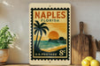 A vintage-style postage stamp from Florida, featuring a palm tree and a sunset over the ocean, is displayed on a shelf next to a wooden cutting board and some lemons.
