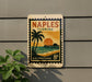 A vintage-style postage stamp from Naples, Florida, featuring a palm tree and a sunset over the ocean, mounted on a wall.
