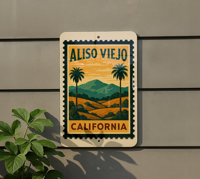 A vintage-style sign with a palm tree and landscape design, mounted on a wall, with a plant to the left.