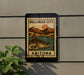 a sign for Bullhead City, Arizona, with a fish illustration and a mountain landscape.