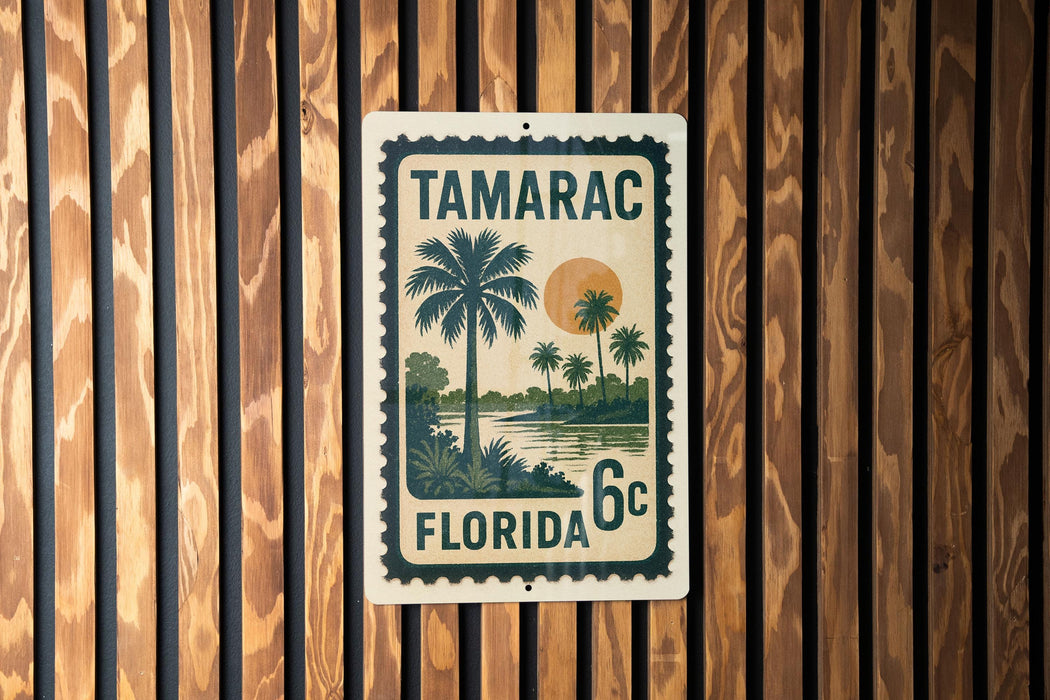 A vintage-style stamp or sign with the text "TAMARAC FLORIDA 6c" printed on it, featuring a palm tree and a sunset landscape.