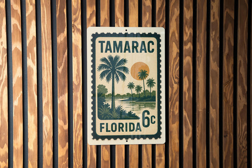 A vintage-style stamp or sign with the text "TAMARAC FLORIDA 6c" printed on it, featuring a palm tree and a sunset landscape.