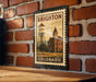 A vintage-style metal stamp depicting a water tower and a building, with the text "BRIGHTON COLORADO" printed on it, is displayed on a brick wall.