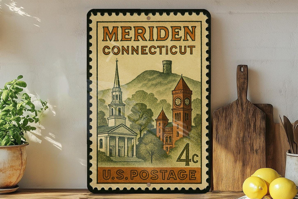 A vintage postage stamp from Meriden, Connecticut, featuring a church and a clock tower, displayed on a shelf with kitchen utensils and a potted plant.