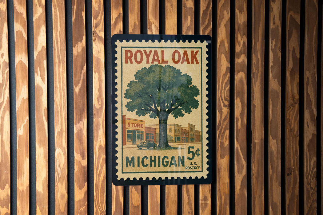 A vintage-style postage stamp from Michigan, featuring a tree and a store, is displayed on a wooden wall.