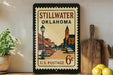A vintage-style postage stamp from Stillwater, Oklahoma, featuring an illustration of a street scene with a church and buildings.