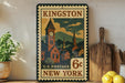 A vintage-style postage stamp from the United States Postal Service, featuring a town scene with a clock tower, is displayed on a shelf next to a wooden cutting board and some potted plants.