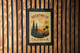 A vintage postage stamp from Brentwood, California, featuring a landscape with palm trees and mountains.