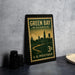 A vintage-style postage stamp from Wisconsin, featuring a silhouette of a city skyline and a river, placed on a countertop next to some camera equipment.