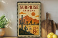 A vintage-style postage stamp from Arizona, featuring a desert landscape with mountains, cacti, and buildings, along with the text "Surprise Arizona USA 8c".
