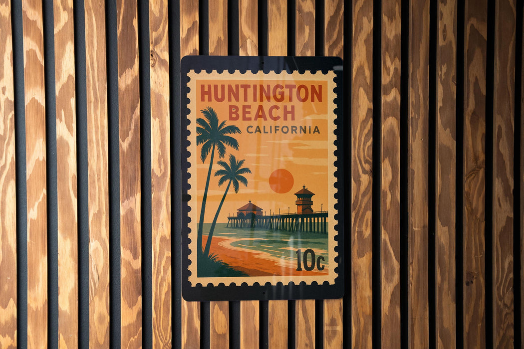 A postage stamp depicting Huntington Beach, California, with a beach scene and palm trees.